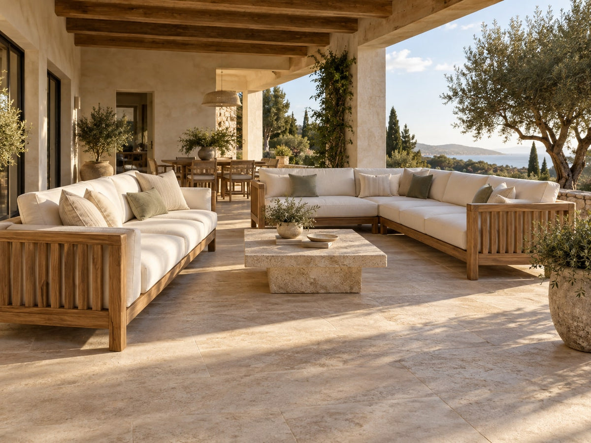Coordinated outdoor sofas and coffee table on a shaded terrace