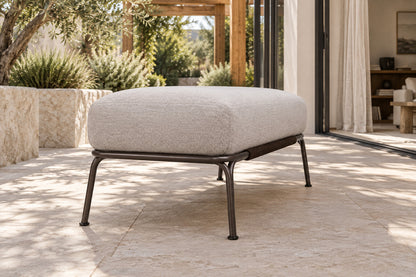 Ischia Ottoman, low near-side-profile lifestyle view