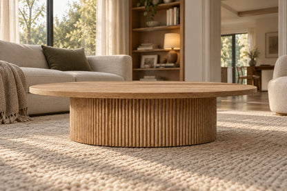 Mulholland Pedestal Round Coffee Table, low near-side-profile lifestyle view
