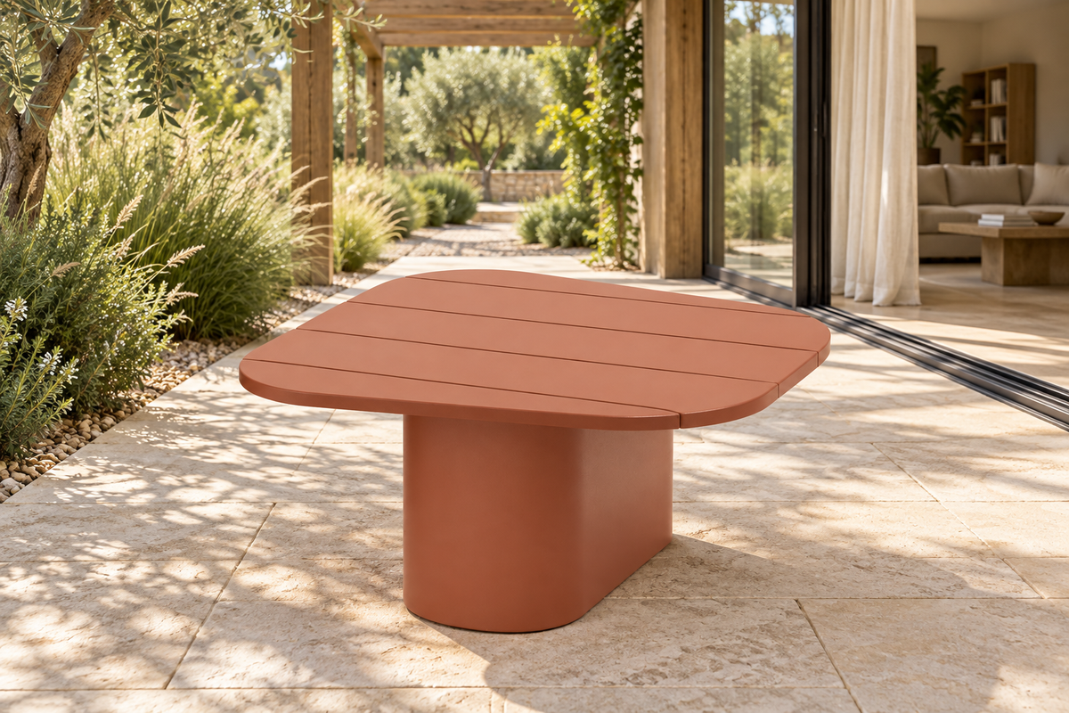 Lifestyle view: Aria aluminium side table beside a planted garden and furnished home