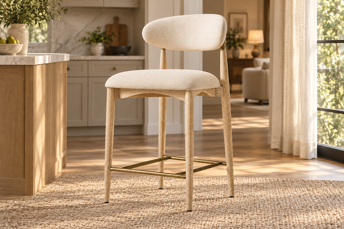 Lifestyle view: Arno Fabric Bar and Counter Stool beside a kitchen island in warm evening light