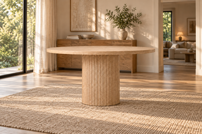 Lifestyle view: Byron Round Dining Table in a warmly lit furnished dining room