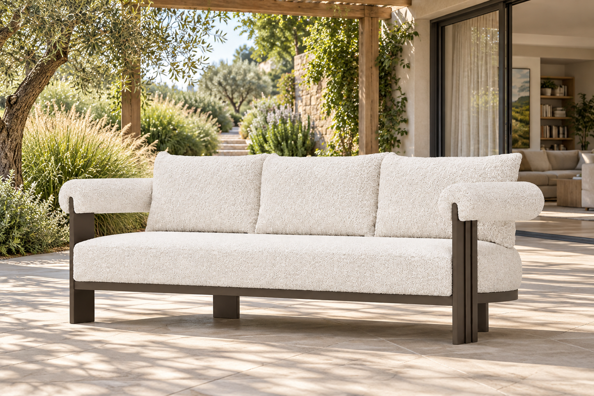 Lifestyle view: Ethereal aluminium sofa beside a garden and furnished living room