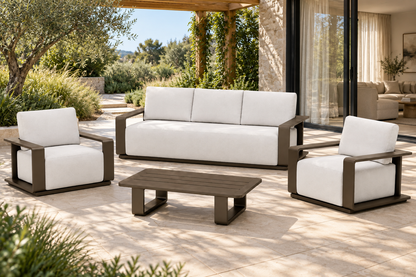 Lifestyle view: Grace aluminium sofa, two lounge chairs and coffee table on a planted garden terrace