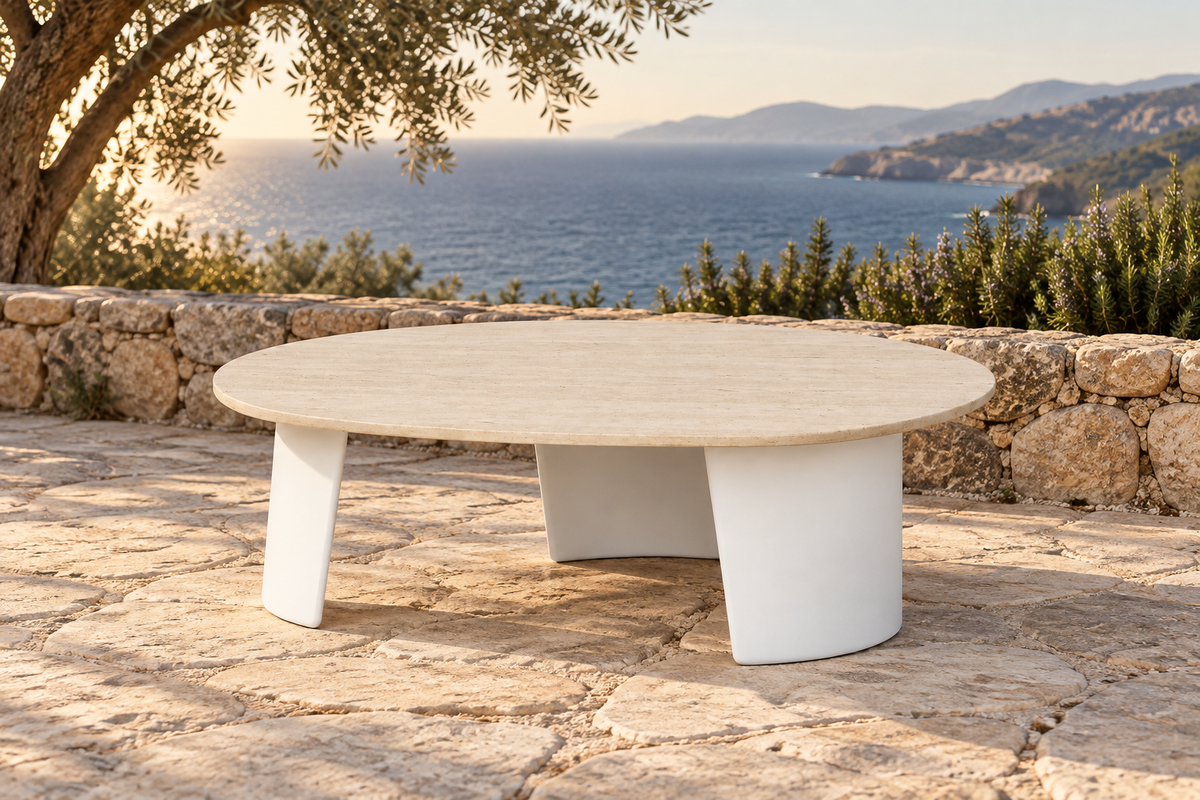 Lifestyle view: Luna aluminium coffee table with a pale stone top on a coastal terrace