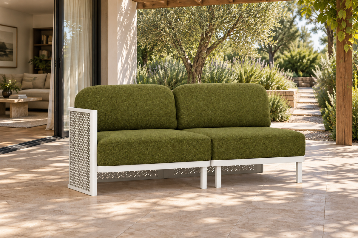 Lifestyle view: Luna aluminium modular two-seat sofa beside a planted garden and furnished home