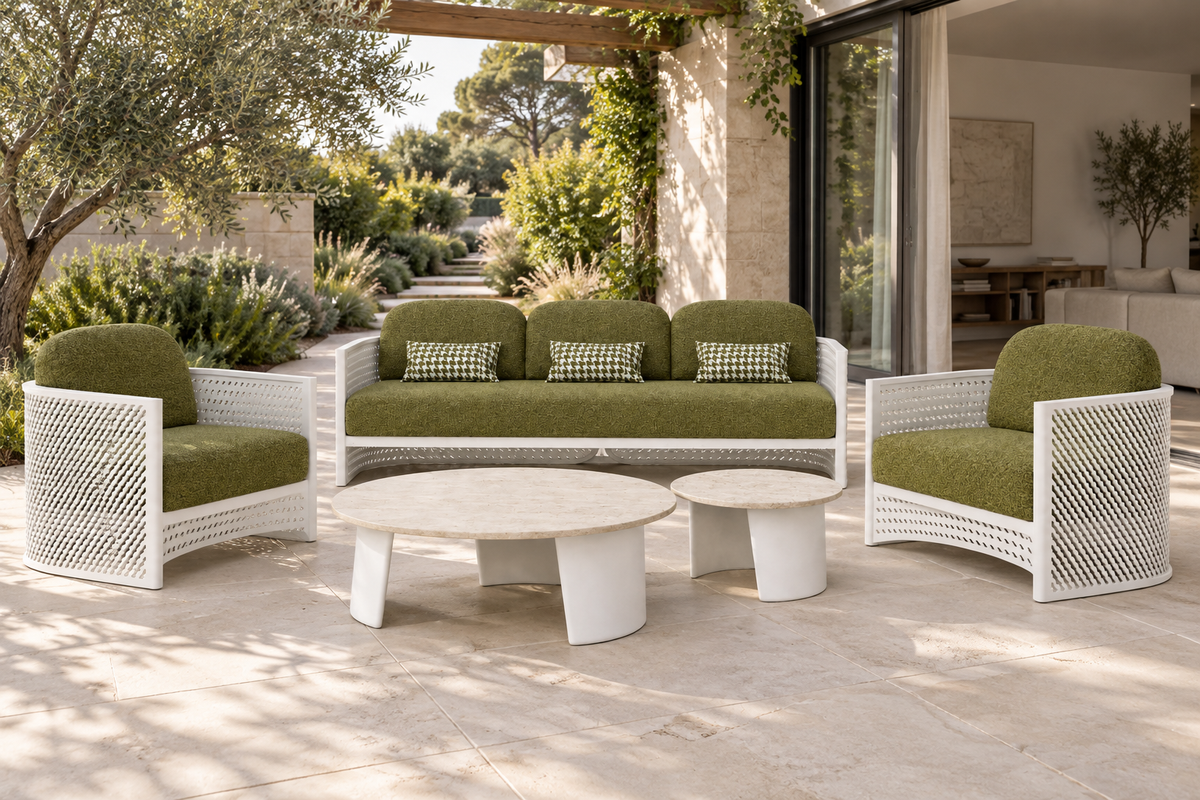 Luna aluminium sofa set with olive cushions and two travertine tables beside a landscaped garden and open living room