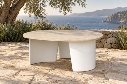 Lifestyle view: Luna aluminium side table with a round stone top on a coastal terrace