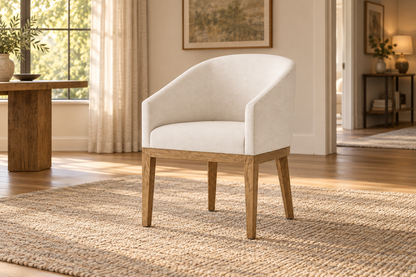 Lifestyle view: Morgan Barrelback Slope Arm Fabric Dining Armchair in a warmly lit furnished interior