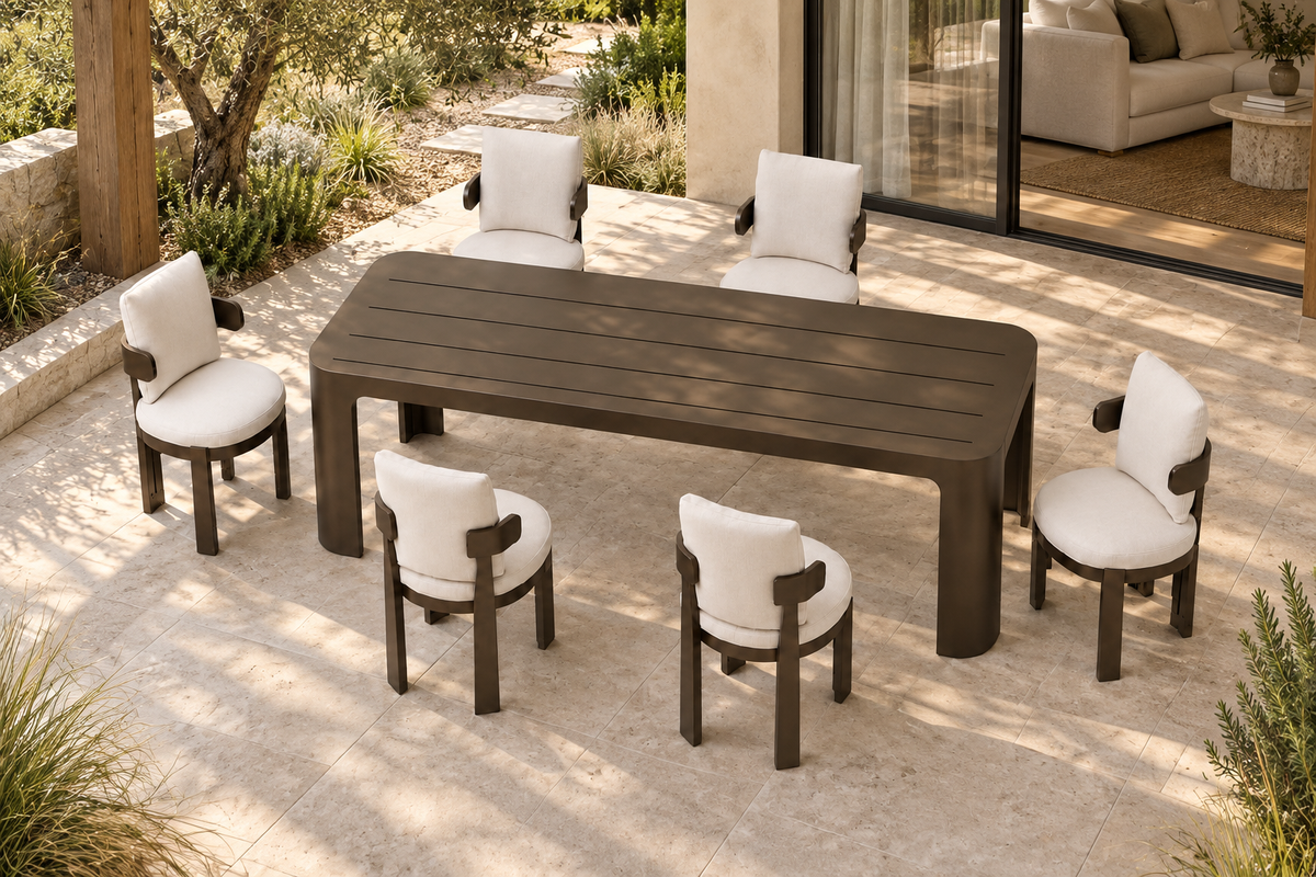 Lifestyle view: Serein aluminium dining table and six chairs on a garden terrace beside an open living room.
