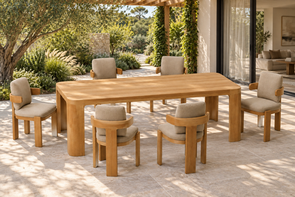 Lifestyle view: Serein teak outdoor dining set beside a planted garden and furnished home