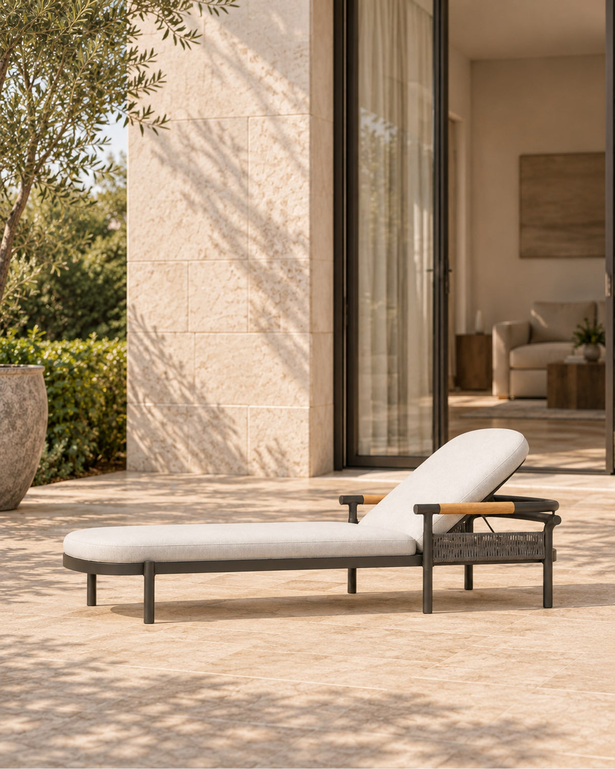 Zenia Sun Lounger in Aluminium in a styled setting