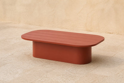 Aria Coffee Table in Aluminium, photographed in a quiet outdoor courtyard