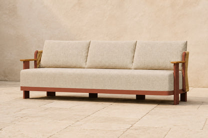 Aria Sofa in Aluminium, photographed in a quiet outdoor courtyard