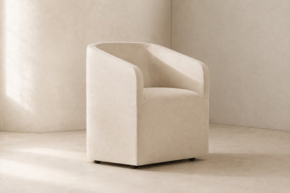 Ellison Barrelback Slope Arm Fabric Dining Armchair, photographed in a quiet dining room