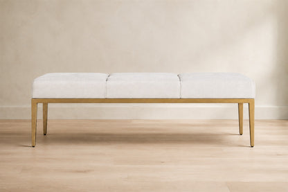 Emi Tufted Bench — Aged Brass, photographed in a quiet bedroom