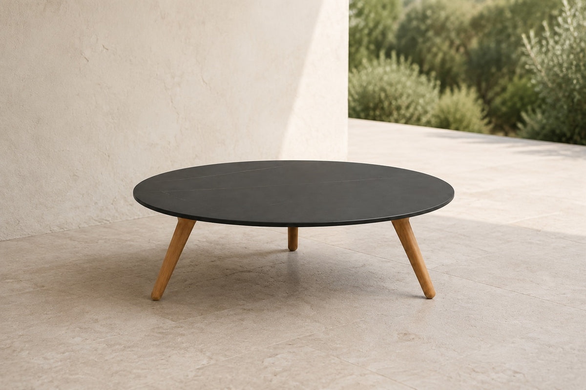 Marisol 70 cm coffee table with dark solid circular top and three timber legs, lifestyle room-2