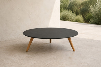 Marisol 70 cm coffee table with dark solid circular top and three timber legs, lifestyle room-2