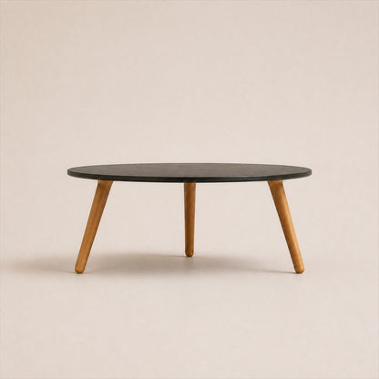 Marisol 70 cm coffee table with dark solid circular top and three timber legs, side view