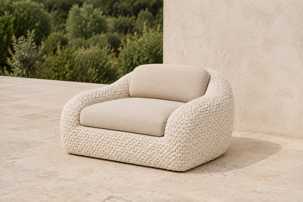 Marisol bone rope lounge chair with one seat and one back cushion, photographed on a travertine terrace