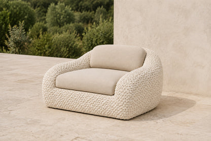 Marisol bone rope lounge chair with one seat and one back cushion, photographed on a travertine terrace