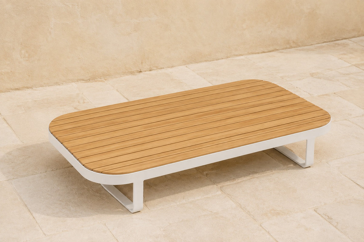Vela Modular Coffee Table in Aluminium, photographed in a quiet outdoor courtyard