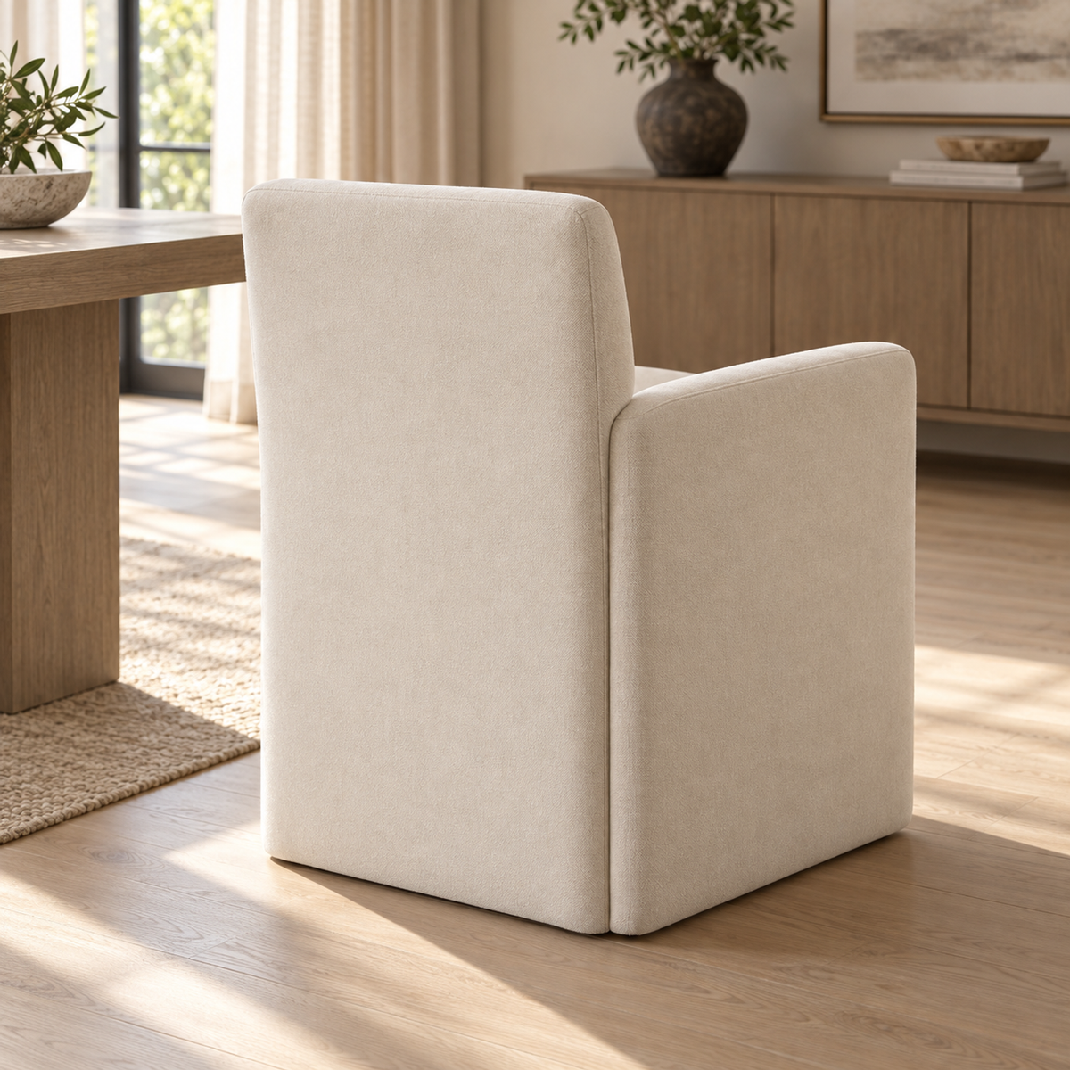 Lifestyle view: Aurelie Track Arm Fabric Dining Armchair, photographed in a quiet interior
