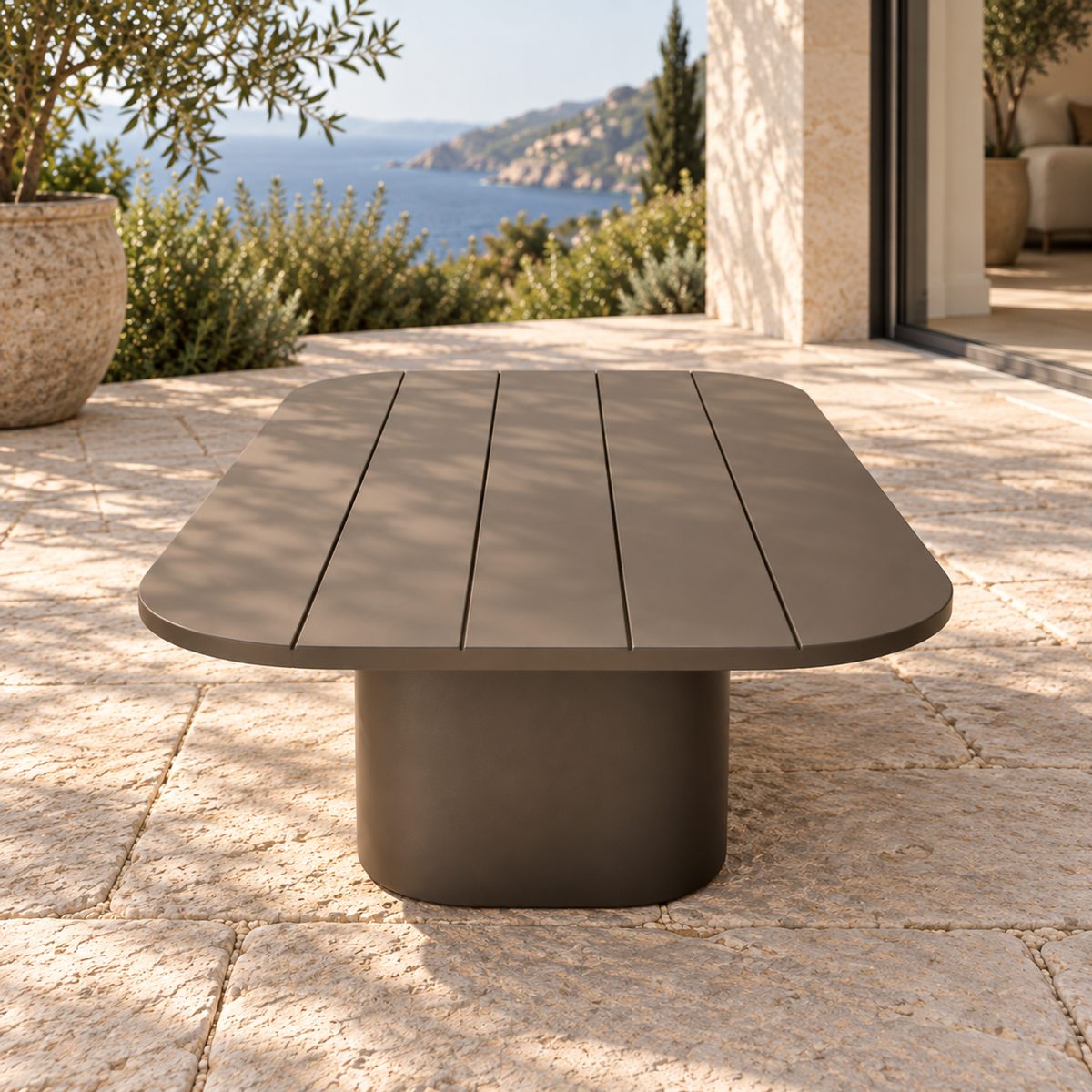 Lifestyle view: Ethereal Coffee Table in Aluminium, short-end view on a coastal home terrace