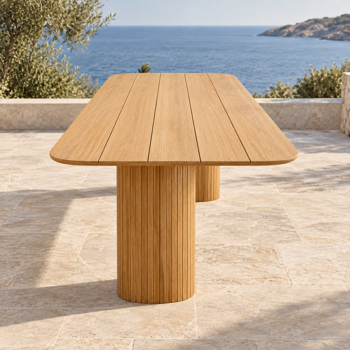 Lifestyle view: Ethereal Dining Table in Teak, short-end view looking along the tabletop on a coastal terrace