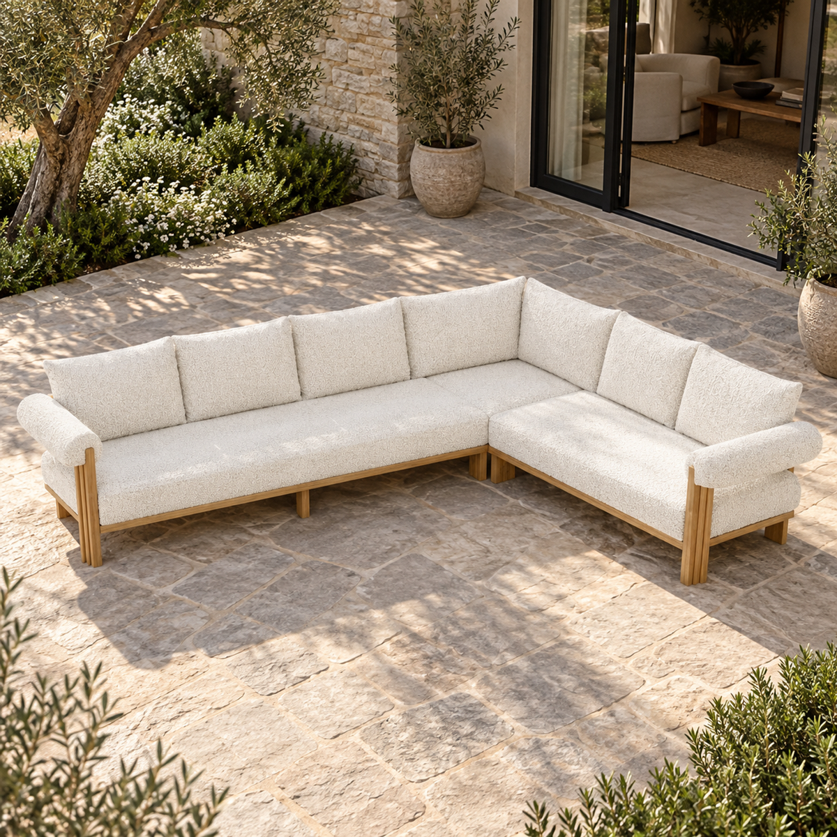 Lifestyle view: Ethereal L-Sectional in Teak, elevated front view in a garden courtyard