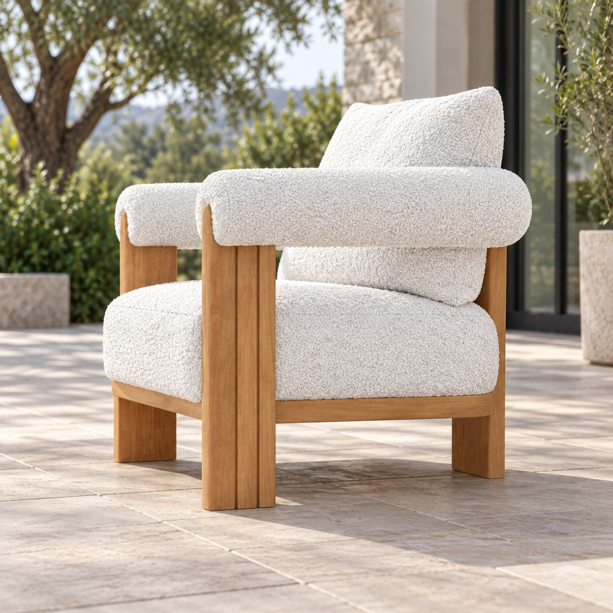Lifestyle view: Ethereal Lounge Chair in Teak, low side-oriented view on a garden terrace