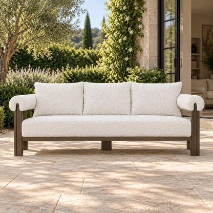 Lifestyle view: Ethereal Sofa in Aluminium, frontal view beside an open living room and planted courtyard