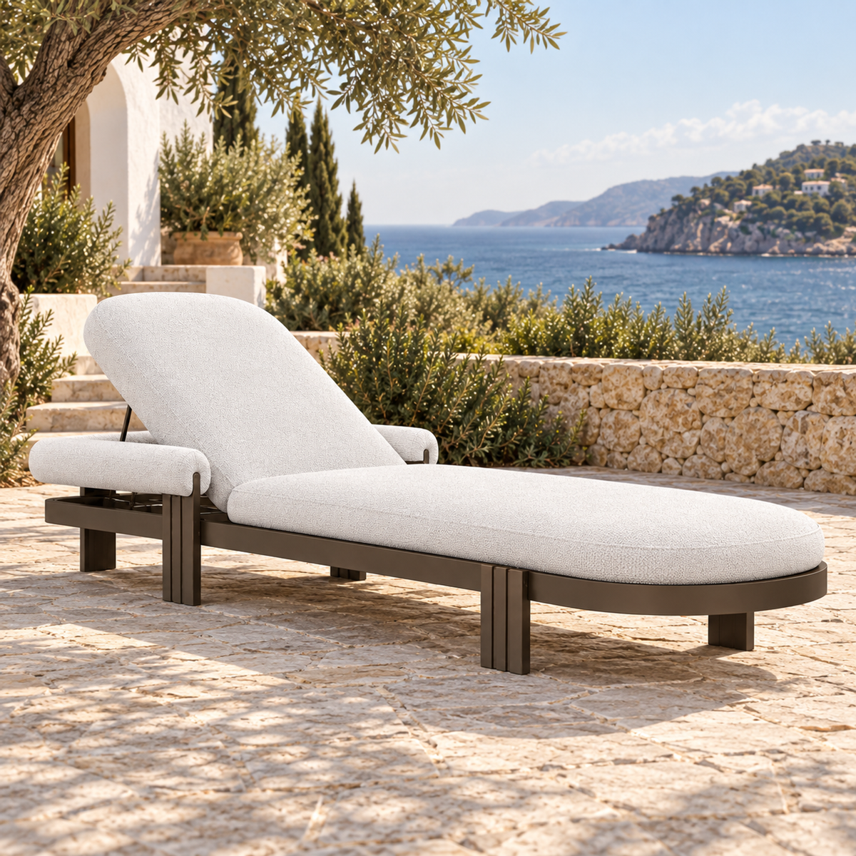 Lifestyle view: Ethereal Sun Lounger in Aluminium, opposite diagonal view on a planted coastal terrace