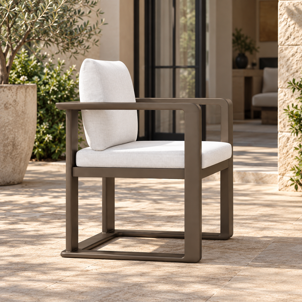 Grace aluminium dining chair, strong left side view on a furnished home terrace