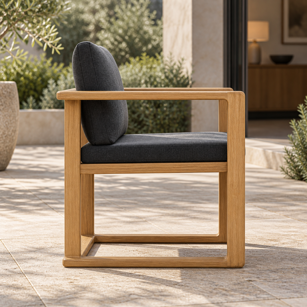 Grace Dining Chair in Teak, side profile on a furnished home terrace