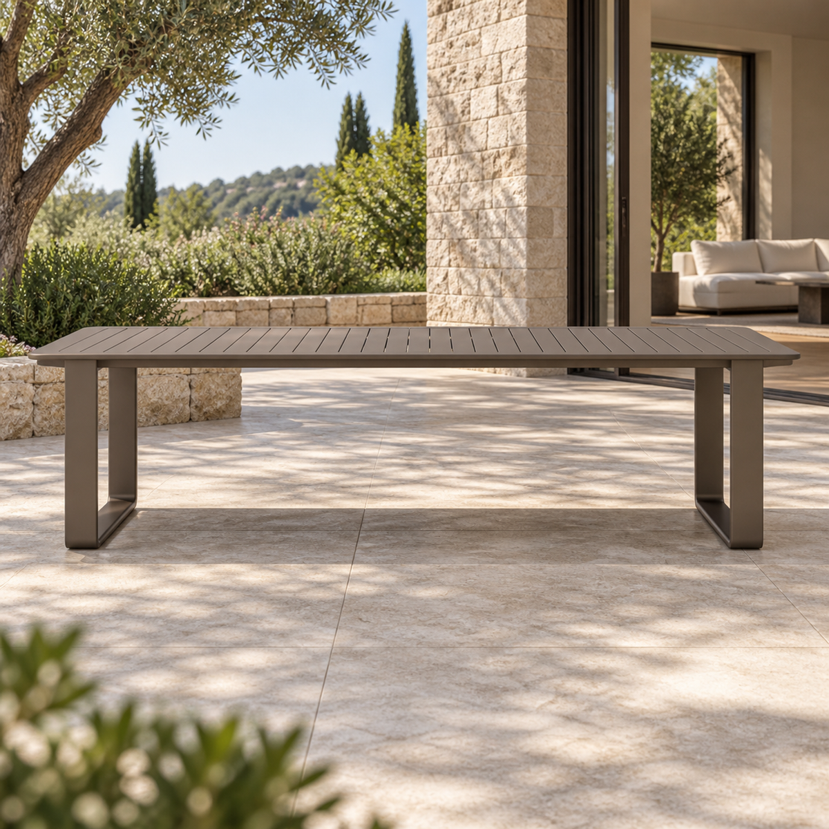 Grace aluminium dining table, straight long-side front view on a furnished home terrace