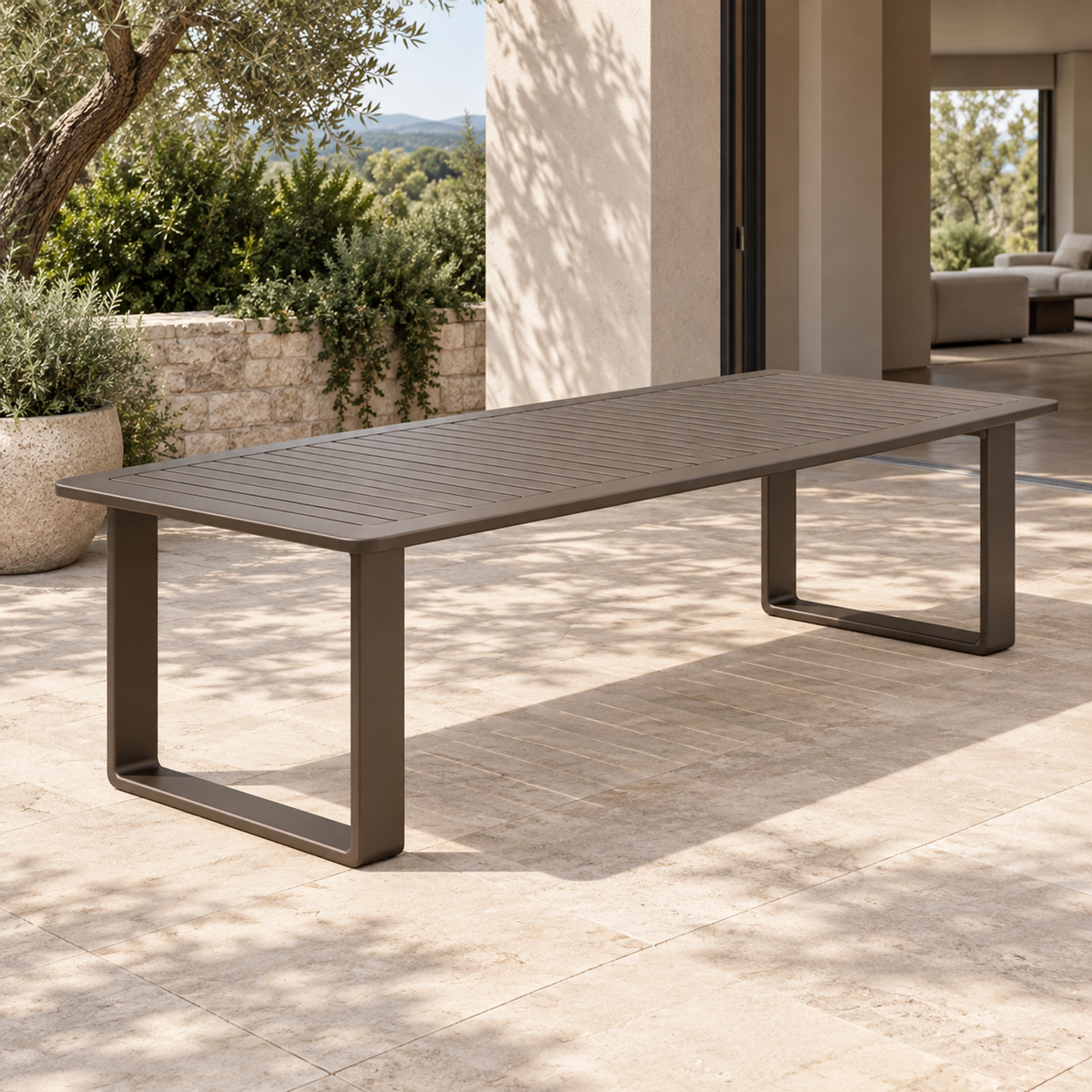 Lifestyle view: Grace aluminium dining table, left three-quarter view on a furnished home terrace