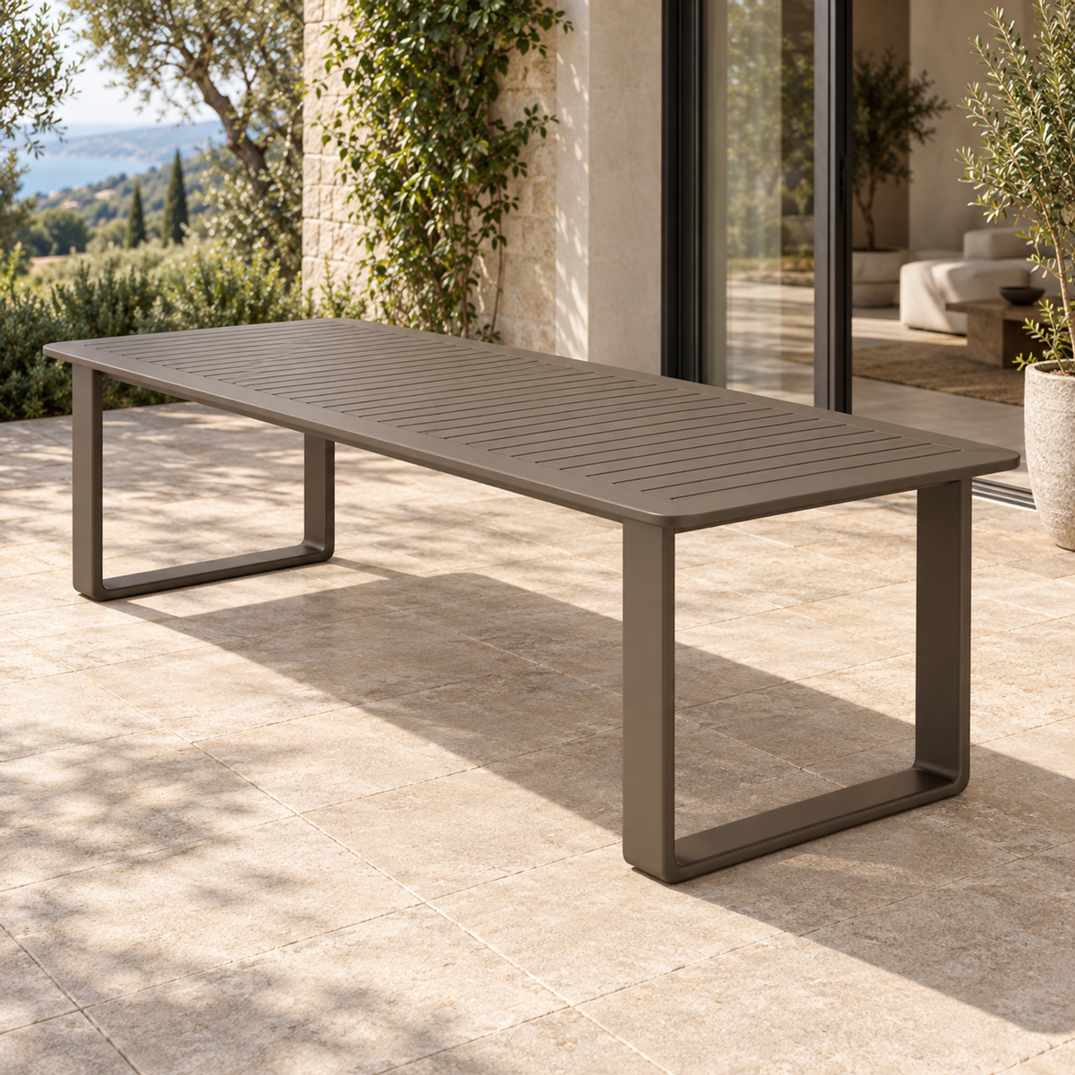 Grace aluminium dining table, right three-quarter view on a furnished home terrace