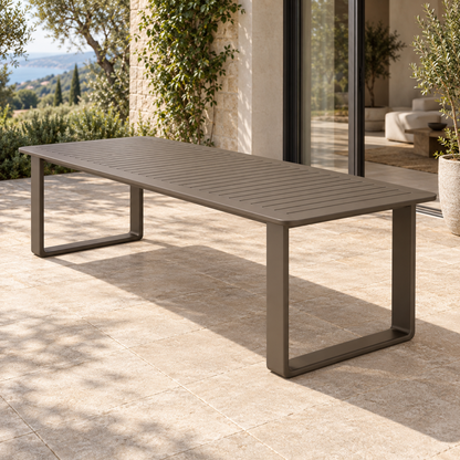 Grace aluminium dining table, right three-quarter view on a furnished home terrace