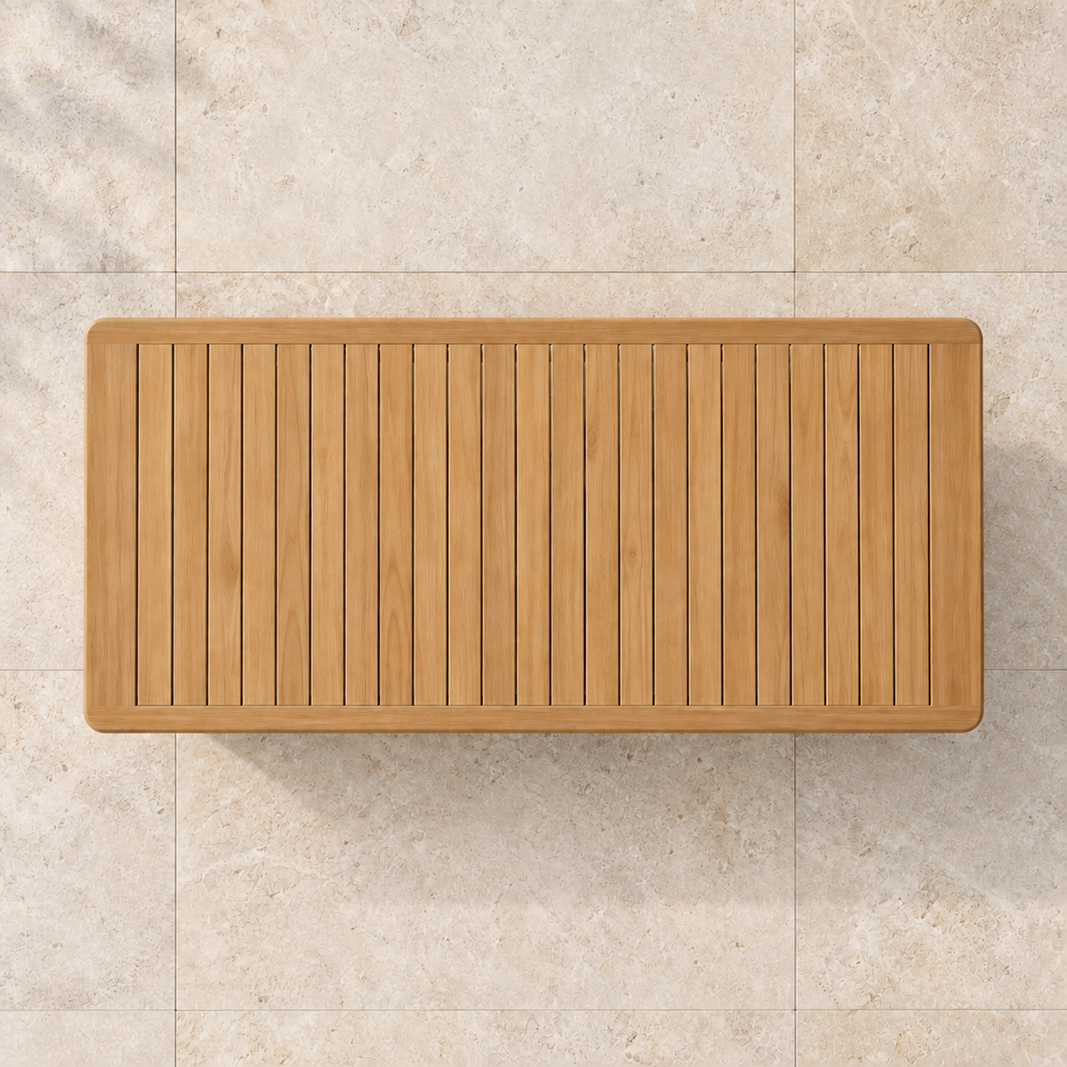 Grace teak dining table, overhead view on stone paving