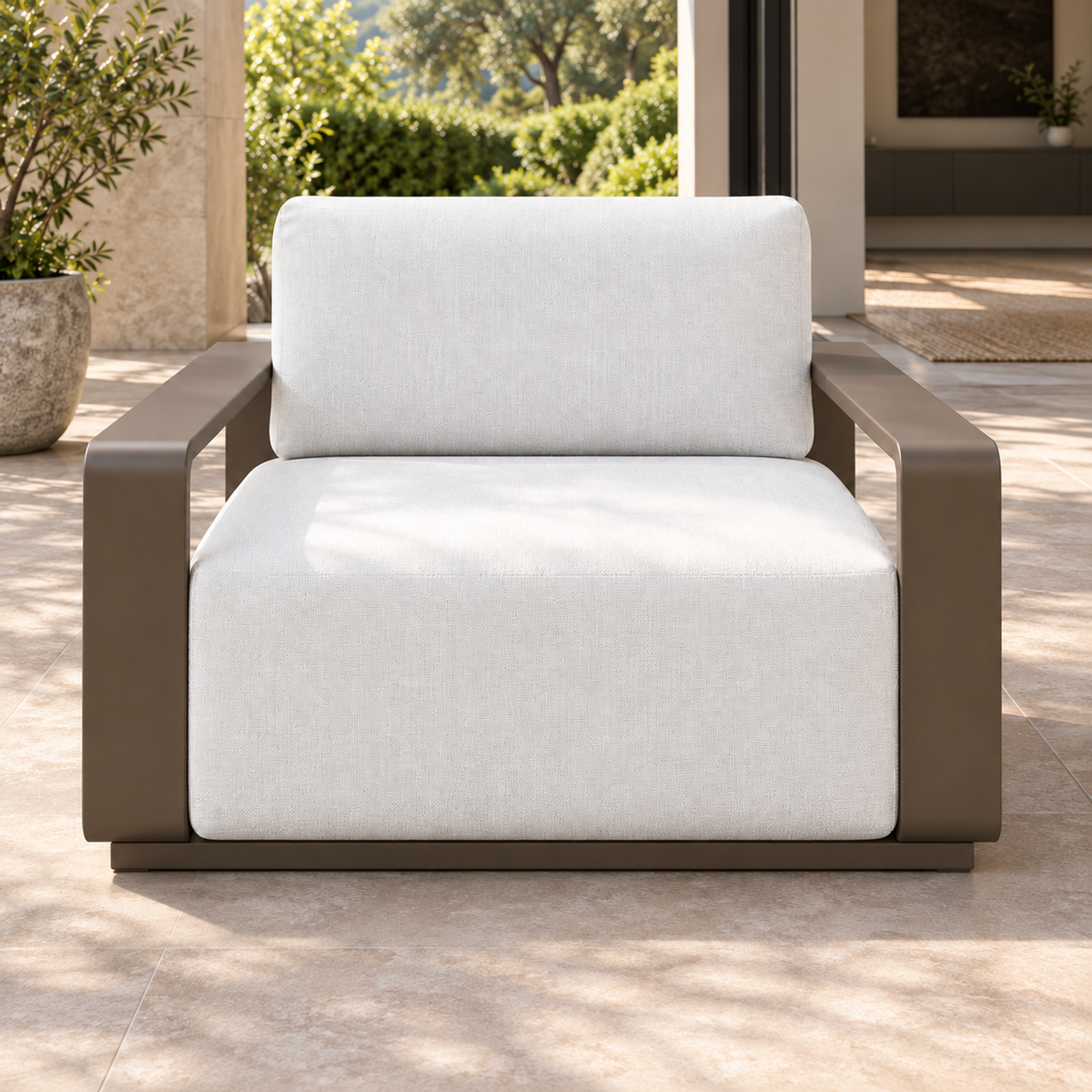 Grace aluminium lounge chair, straight front view beside a furnished living room