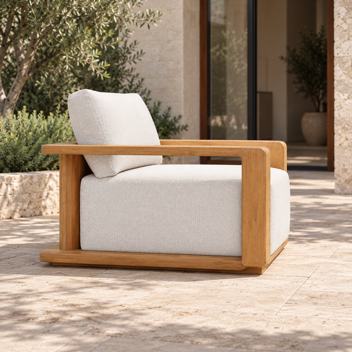 Grace Lounge Chair in Teak, side view on a home terrace