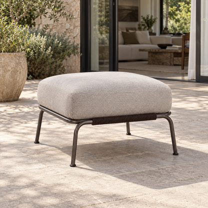 Lifestyle view: Ischia Ottoman, photographed in a quiet outdoor courtyard