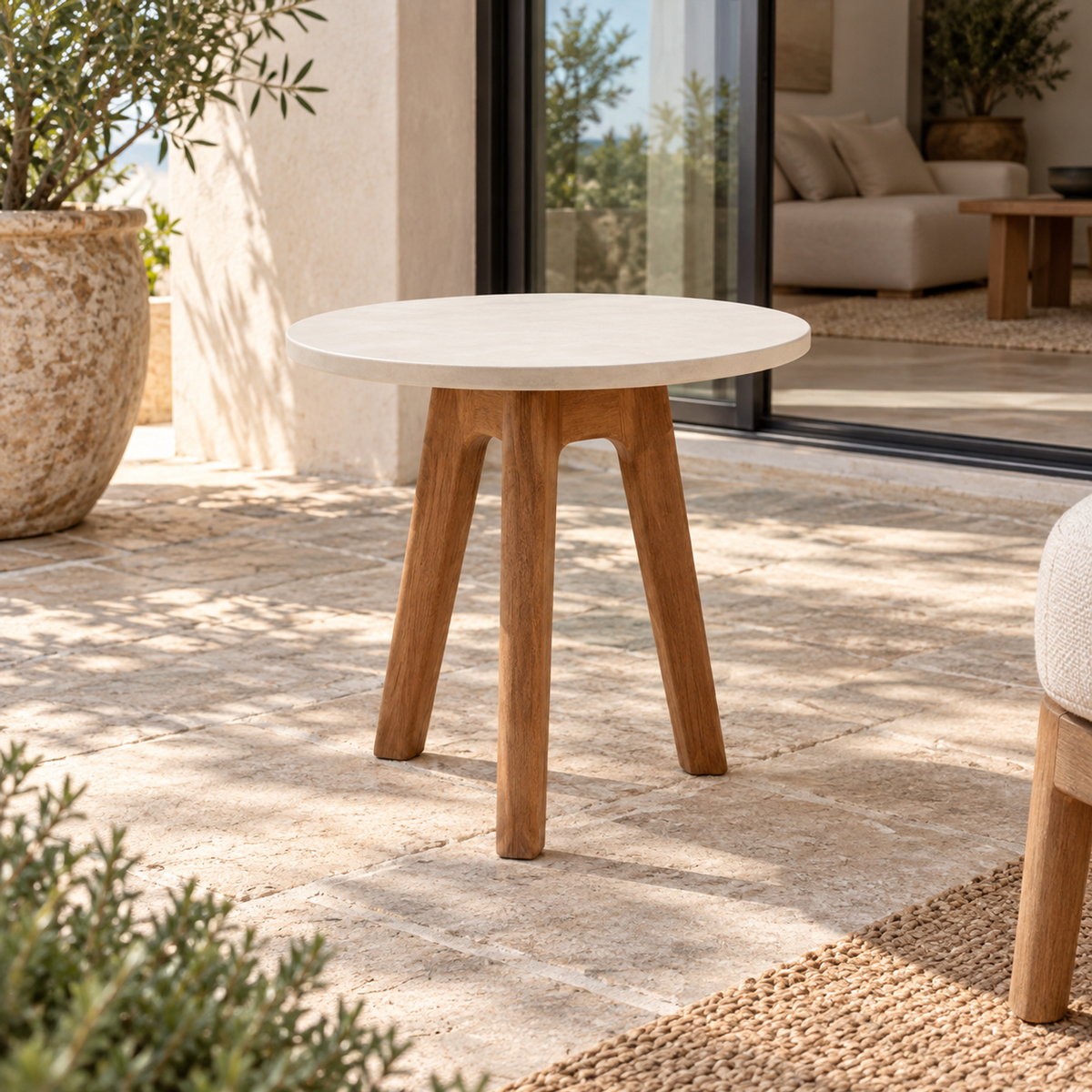 Lifestyle view: Menorca Side Table, photographed in a quiet outdoor courtyard
