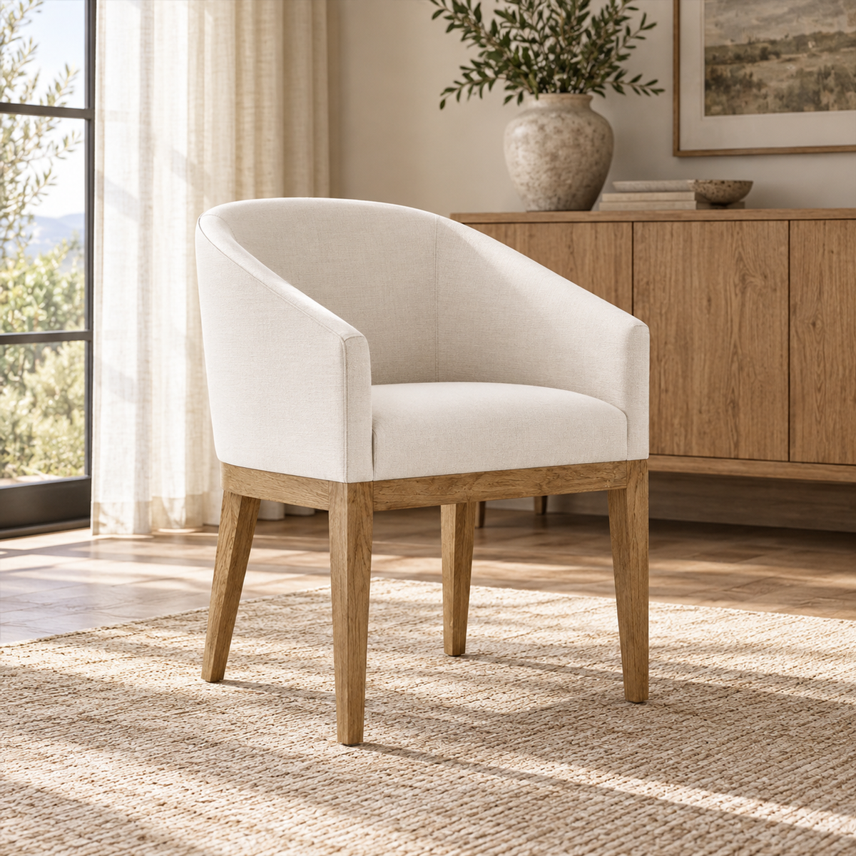 Lifestyle view: Morgan Barrelback Slope Arm Fabric Dining Armchair in a sunlit furnished interior