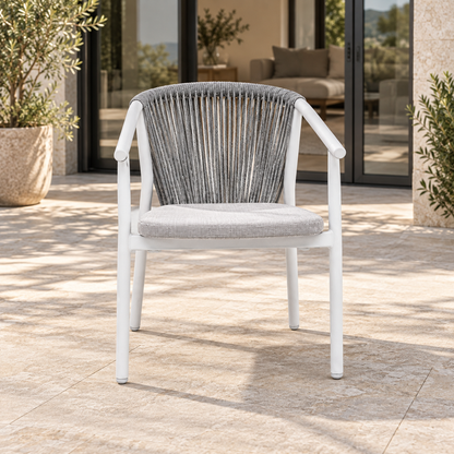 Lifestyle view: Paros Dining Chair, photographed in a quiet outdoor courtyard