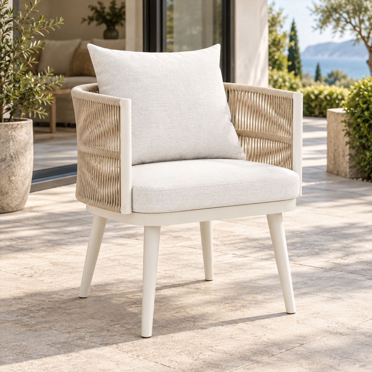 Lifestyle view: Ripple Dining Chair in Aluminium, left three-quarter view beside a furnished home