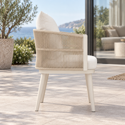 Lifestyle view: Ripple Dining Chair in Aluminium, side profile on a coastal terrace