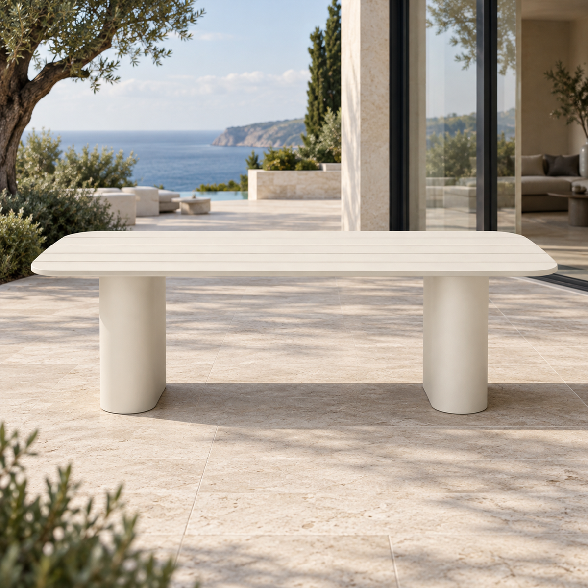 Lifestyle view: Ripple Dining Table in Aluminium, straight long-side frontal view on a coastal home terrace