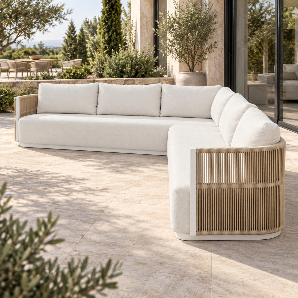 Lifestyle view: Ripple L-Sectional in Aluminium, strong end view beside a furnished garden home